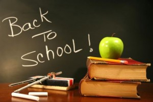 School books with apple on desk